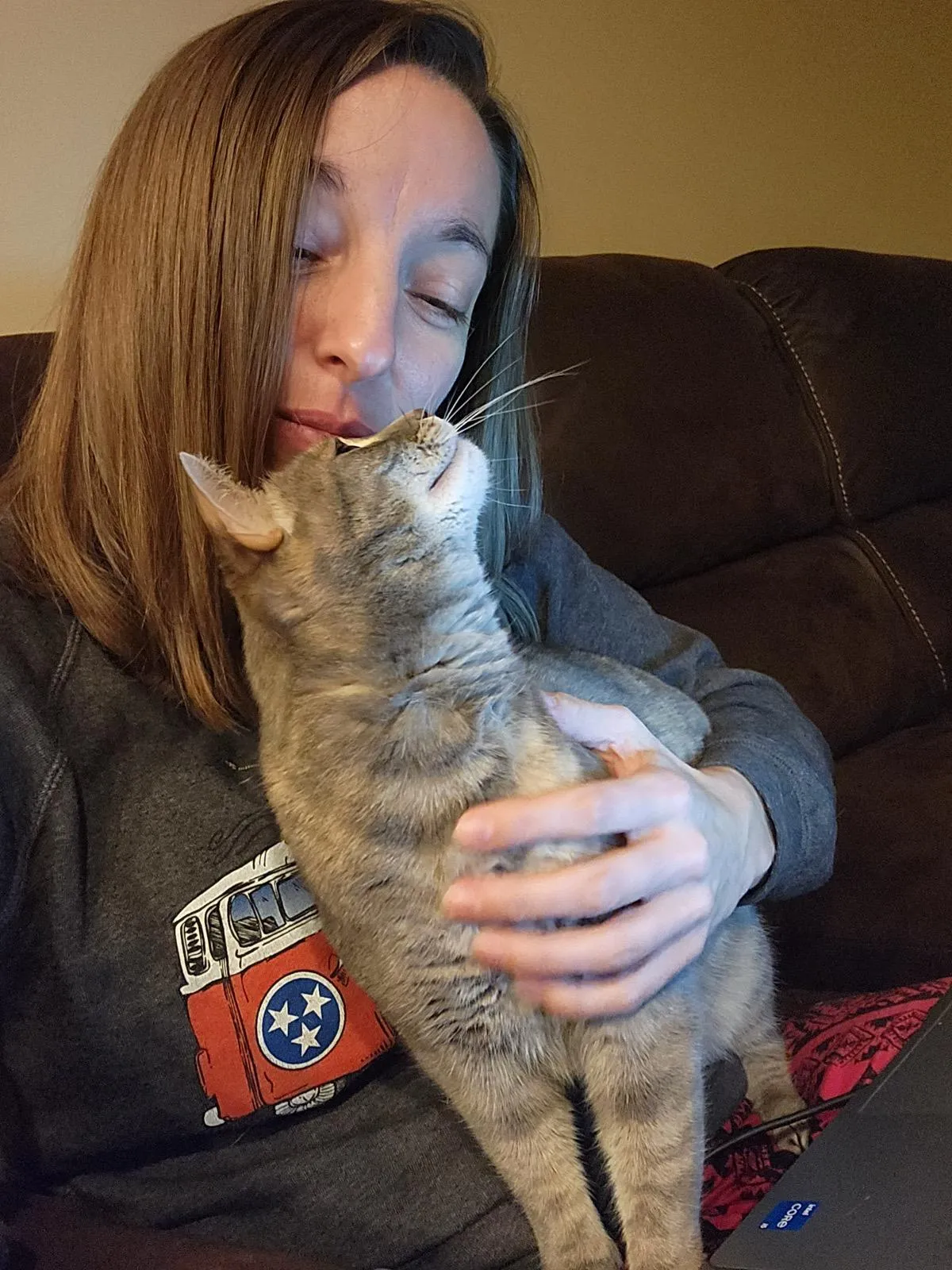 One of Jessica's cats reaching up to touch her nose